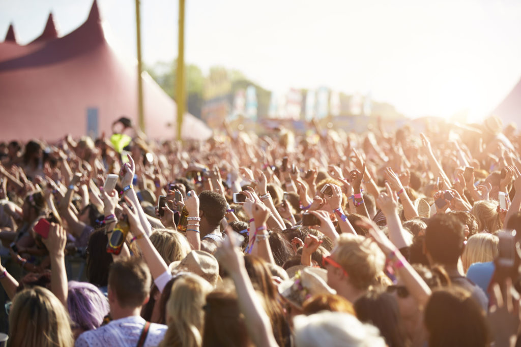 An image of an audience at an outdoor festival