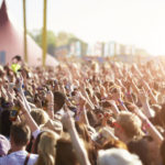 An image of an audience at an outdoor festival