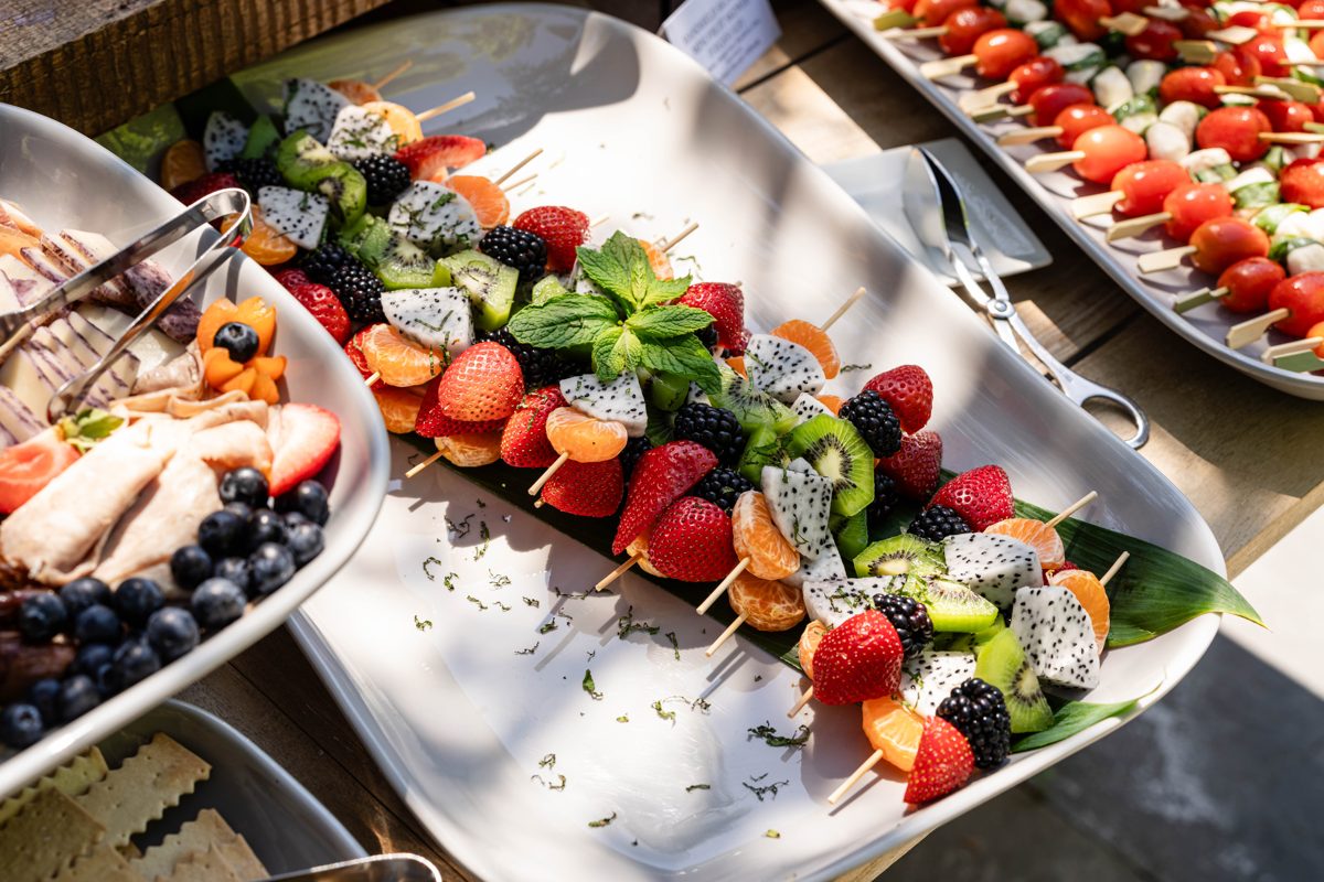 Caprese skewers with cherry tomato, mozzarella and basil prepared on site at a Los Altos graduation party, Handheld Catering