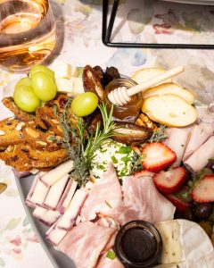 Handheld Catering farm-to-fork seasonal grazing board with artisan cheeses, fresh fruit and rose wine — Silicon Valley catering