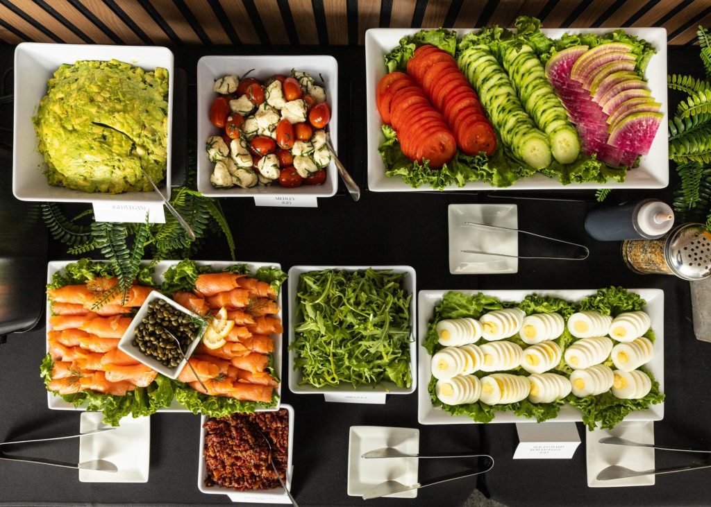 Fresh locally sourced vegetables, greens and smoked salmon on a Handheld Catering buffet, a Certified California Green Business since 2018